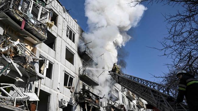 Firefighters work on a fire in a building after bombings on the eastern Ukraine town of Chuguiv. Picture: Aris Messinis / AFP