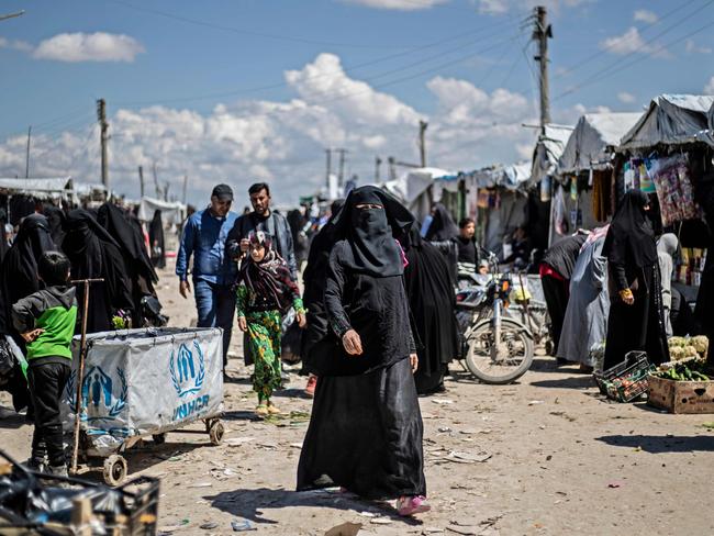 Women walk in a market inside the al-Hawl camp for displaced people, in al-Hasakeh governorate in northeastern Syria. Picture: AFP