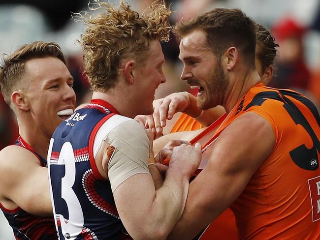 James Harmes and Clayton Oliver get physical with Matt Flynn during the clash between the Dees and Giants. Picture: AFL Photos/Getty Images