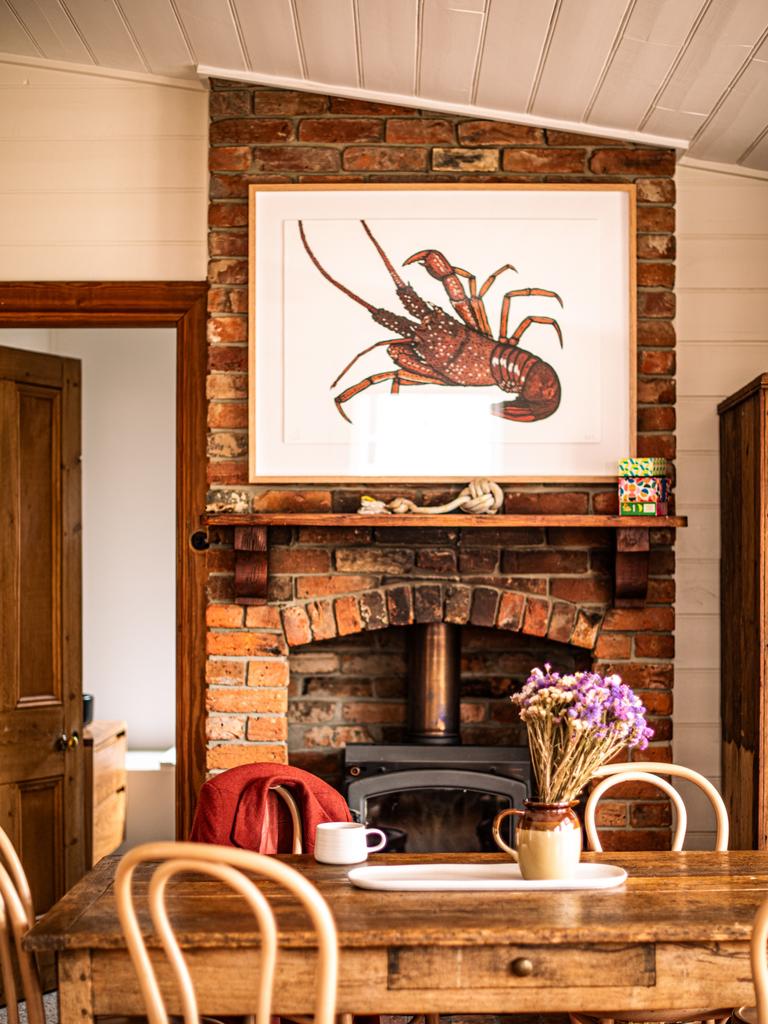 Homeowners Hugo and Milly Hubbard have let the heritage features of the home shine, including the exposed brick fireplace in the open-plan kitchen and dining area. Picture: Em Godfrey