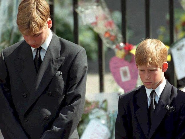 Prince William (left) and Prince Harry, the sons of Diana, Princess of Wales, bow their heads as their mother's coffin is taken out of Westminster Abbey 06 September following her funeral service. The princess was killed 31 August in a car crash in Paris. / AFP PHOTO / POOL / ADAM BUTLER