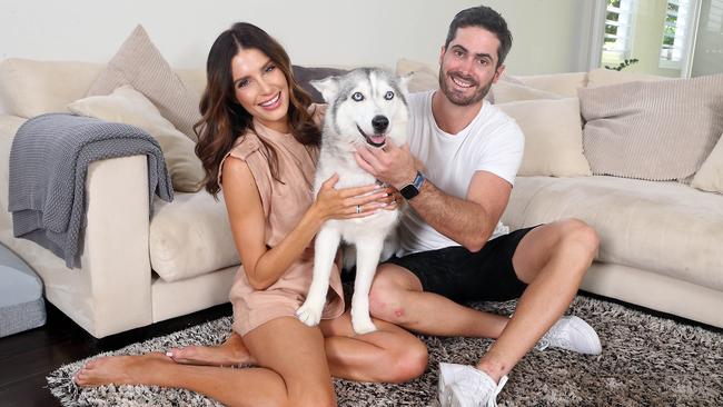 Erin Holland, Ben Cutting and husky Sicari at home. Picture: AAP Image/Richard Gosling