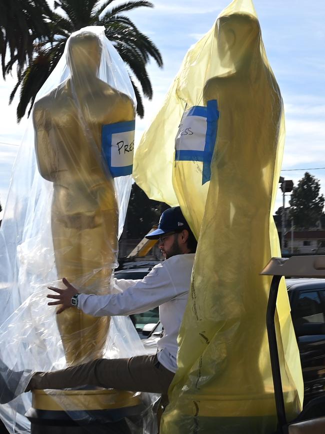 (FILES) In this file photo taken on February 05, 2020 Oscar statues are transported during preparations for the 92nd annual Oscars, in Hollywood, California. - The 93rd Oscars have been postponed by eight weeks to April 25 after the coronavirus pandemic shuttered movie theaters and wreaked havoc on Hollywood's release calendar, the Academy said June 15, 2020. (Photo by Robyn Beck / AFP)