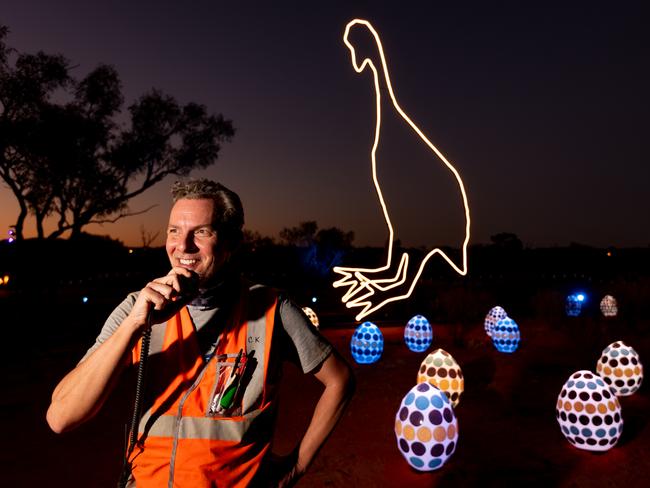 Chris Karstens, Parrtjima Desert Park Precinct Manager prepares for Parrtjima in front of Emu Laying Eggs at Night by Lachlan Dodds-Watson