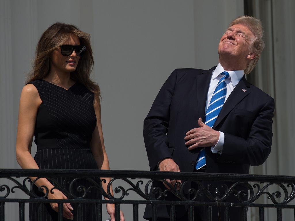 US President Donald Trump looking up a the partial solar eclipse with First Lady Melania Trump from the balcony of the White House in Washington, DC. Picture: AFP