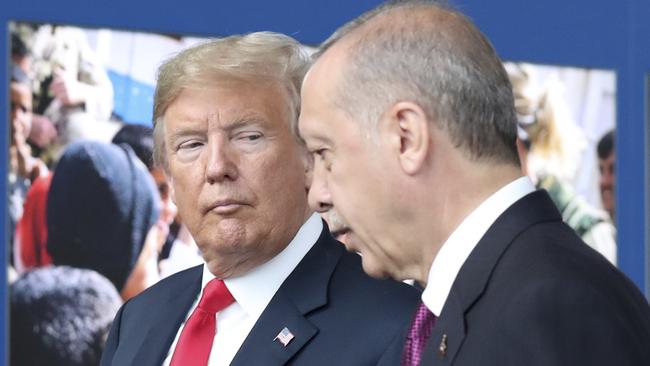 US President Donald Trump talks to Turkish President Recep Tayyip Erdogan as they tour the new NATO headquarters in Brussels. Photo: AP