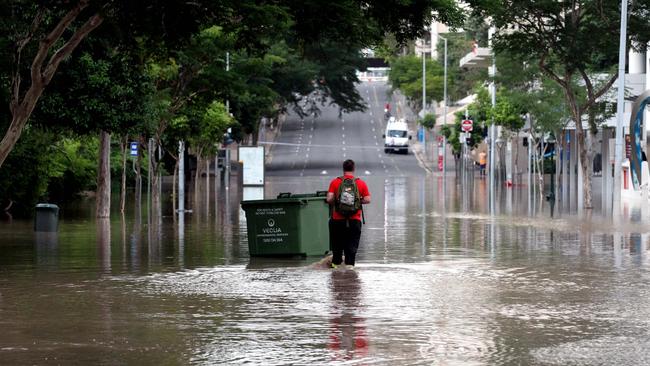 A man wades through flood waters in the Brisbane CBD on January 13, 2011.
