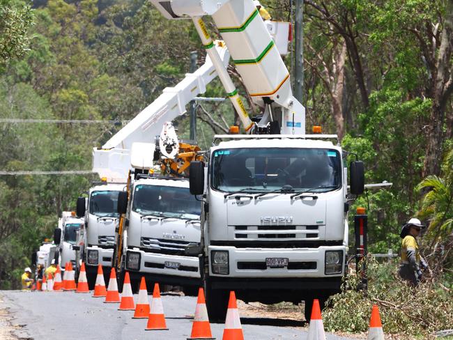 Energex workers restoring power lines at Tamborine on Sunday where over 1000 workers have been deployed from all over the state to help restore power to the region devastated by the Christmas Day storms. Picture Lachie Millard