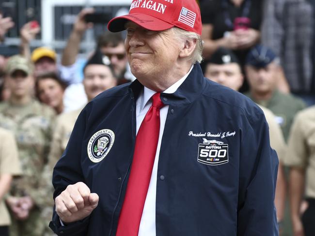 President Donald Trump walks with his granddaughter Carolina before the NASCAR Daytona 500 auto race at Daytona International Speedway, Sunday, Feb. 16, 2025, in Daytona Beach, Fla. (Chris Graythen/Pool via AP)