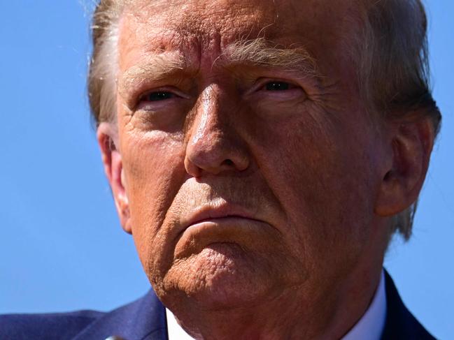 TOPSHOT - Former US President and Republican presidential candidate Donald Trump speaks to the media in Swannanoa, North Carolina, on October 21, 2024, after observing cleanup efforts in the aftermath of Hurricane Helene, which devastated the region. (Photo by Jim WATSON / AFP)