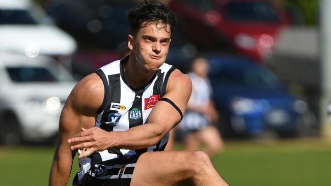 Trent Cody takes a kick for Narre Warren. Picture: (AAP Image/James Ross)