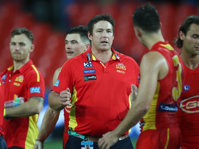 Suns coach Stuart Dew talks to his team during the round 1 AFL match between the Gold Coast Suns and the Port Adelaide Power at Metricon Stadium on March 21, 2020 in Gold Coast, Australia. (Photo by Jono Searle/AFL Photos/Getty Images)