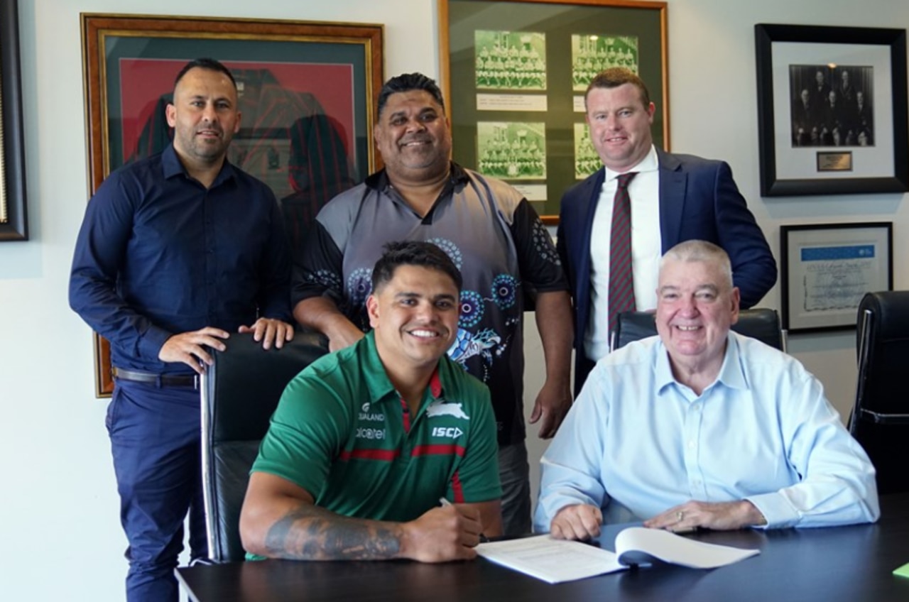 Latrell Mitchell signs with the Rabbitohs, flanked by his agent Matt Rose (back left).