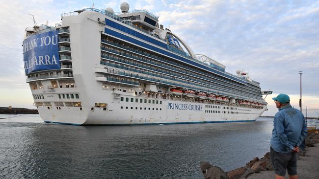 The Ruby Princess cruise ship is watched by a small gathering of residents as it departs Port Kembla in Wollongong. Picture: AAP