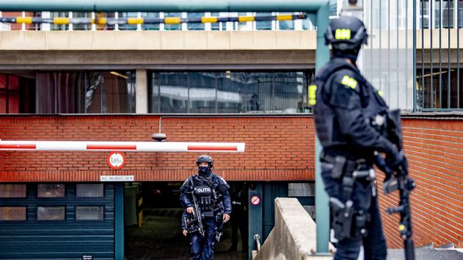 Police officers stand guard as a transport arrives at the extra secure court in Rotterdam, on June 22, 2021, prior to the hearing on the extradition of Chi Lop Tse. Picture: AFP