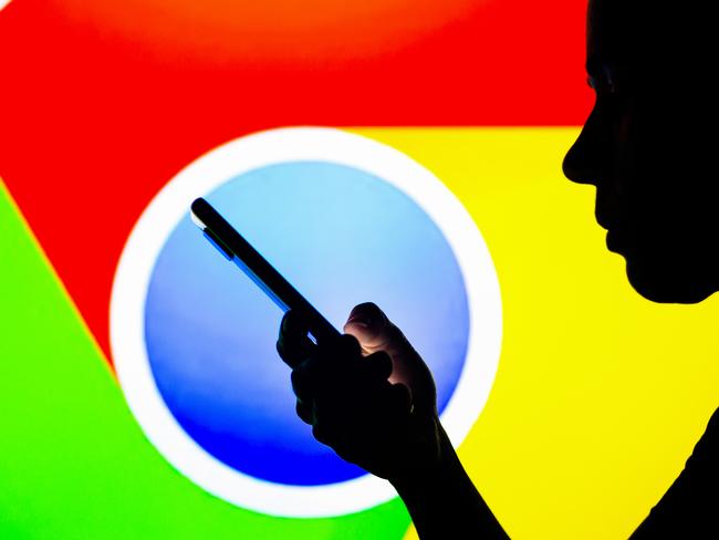 BRAZIL - 2022/04/27: In this photo illustration, the Google Chrome logo is seen in the background of a silhouetted woman holding a mobile phone. (Photo Illustration by Rafael Henrique/SOPA Images/LightRocket via Getty Images)