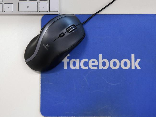 (FILES) This file photo illustration taken on December 4, 2017 shows mousepad with the Facebook logo at Facebook's new headquarters at Rathbone Place in central London. - Facebook was branded "arrogant" and "unconscionable" for banning Australian users from sharing news on February 18, 2021, as its defiant response to government regulation inadvertently crippled the pages of several emergency services. (Photo by Daniel LEAL-OLIVAS / AFP)