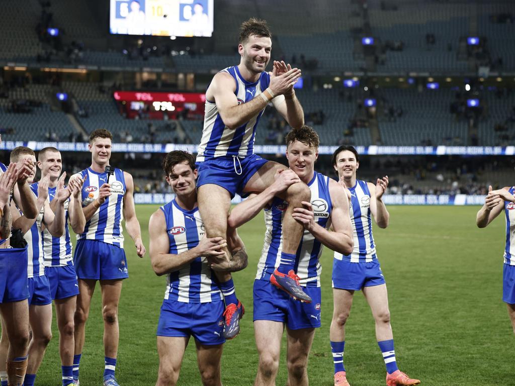 Luke McDonald chaired off after his 200th game. Picture: Daniel Pockett/Getty Images