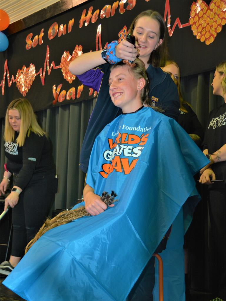 At the St Joseph's College 2023 World's Greatest Shave event is student Emily Chandler getting her hair cut by her support crew and hairdresser Natalie Schmidt from the Hair Room on Russell. Picture: Rhylea Millar