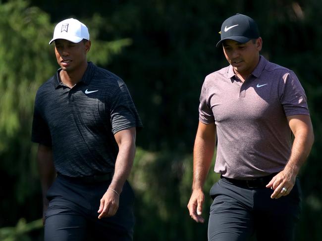 AKRON, OH - AUGUST 03: Tiger Woods (L) and Jason Day of Australia walk across the 10th hole during World Golf Championships-Bridgestone Invitational - Round Two at Firestone at Firestone Country Club South Course on August 3, 2018 in Akron, Ohio.   Gregory Shamus/Getty Images/AFP == FOR NEWSPAPERS, INTERNET, TELCOS & TELEVISION USE ONLY ==