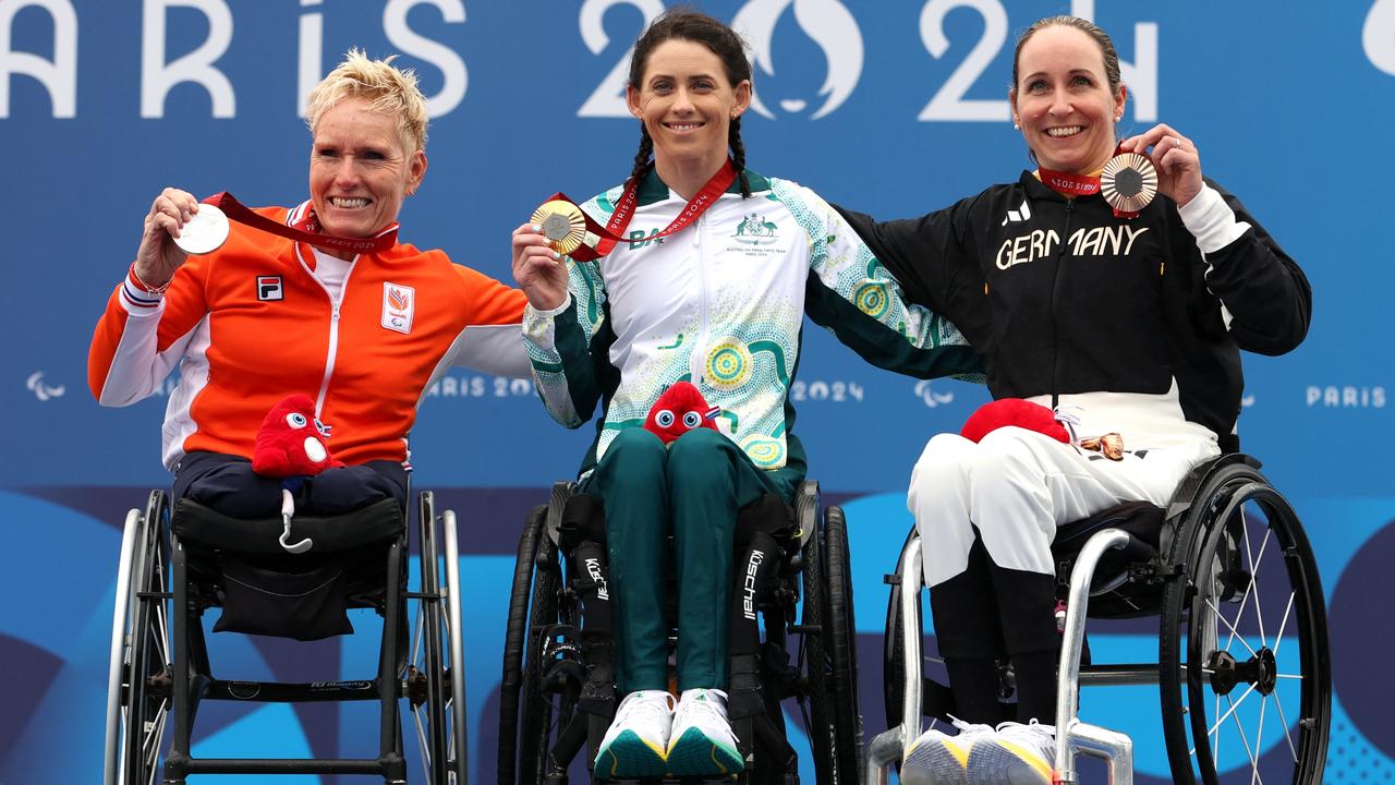 Australia’s gold medallist Lauren Parker enjoys the podium with silver medallist Jennette Jansen of Team Netherlands, left, and bronze medallist Annika Zeyen-Giles of Team Germany, after the women's H1-4 road race on day eight. Picture: Michael Steele/Getty Images