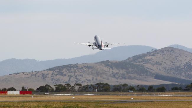 An aircraft takes off from Hobart Airport.