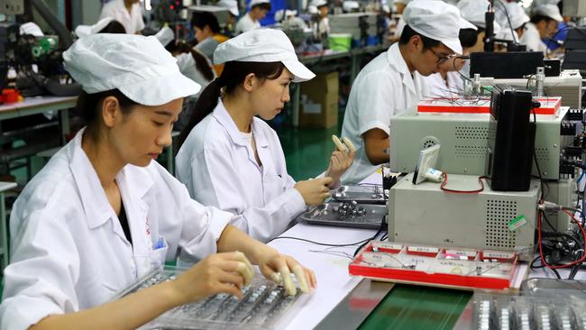 It will be difficult for any government to persuade companies to relocate manufacturing back to home base from China. Picture: AFP