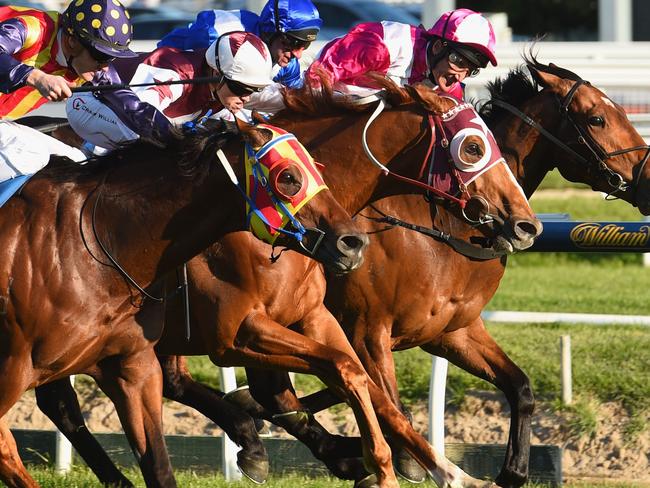 MELBOURNE, AUSTRALIA - SEPTEMBER 26: Craig Williams riding Stratum Star (ctr) defeats Damien Oliver riding Disposition (R) and Mark Zahra riding Under The Louvre (L) in Race 8, the Sir Rupert Clarke Stakes during Melbourne Racing at Caulfield Racecourse on September 26, 2015 in Melbourne, Australia. (Photo by Vince Caligiuri/Getty Images)