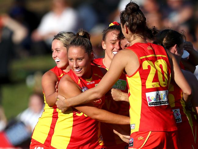 Suns players celebrate during the round four AFLW match between the North Melbourne Kangaroos and the Gold Coast Suns at Arden Street Oval on February 29, 2020 in Melbourne, Australia. (Photo by Kelly Defina/AFL Photos/ via Getty Images)