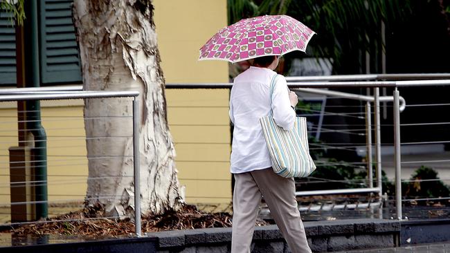 Wet weather hits Ipswich: a woman holding an umbrellaPhoto: Sarah Keayes / Queensland Times