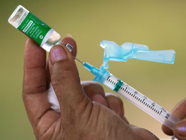 (FILES) In this file photo taken on February 9, 2021 nurse Janete Da Silva Oliveira prepares a dose of the Oxford-AstraZeneca COVID-19 vaccine in the Nossa Senhora Livramento community on the banks of the Rio Negro near Manaus, Amazonas State, Brazil. - Shortages of COVID-19 vaccines have forced several large Brazilian cities to suspend administering second doses, officials and media reports said on May 3, 2021, the latest breakdown in the hard-hit country's troubled immunization drive. Seven of Brazil's 26 state capitals have stopped administering the booster shot of Chinese-developed CoronaVac because of a lack of supply, according to news site G1. (Photo by MICHAEL DANTAS / AFP)