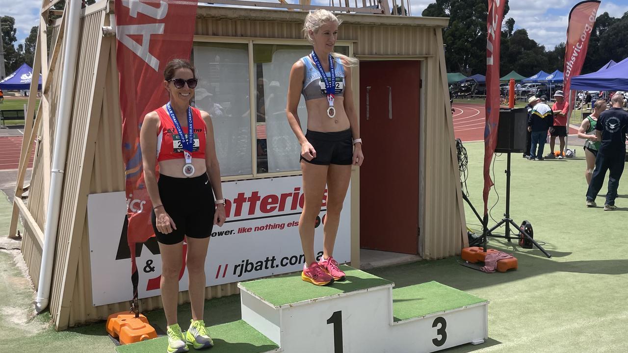 South Coast's Laura Tomic claims gold in the 400m over 40 female competition. Join her on the podium is Donna Braden. Picture: Shane Jones.