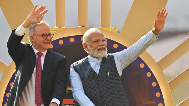 Indian Prime Minister Narendra Modi (R) and Australia's Prime Minister Anthony Albanese (L) wave to spectators at the Narendra Modi stadium in Ahmedabad on March 9, 2023, before the start of the fourth and final Test cricket match between India and Australia. (Photo by Punit PARANJPE / AFP) / ----IMAGE RESTRICTED TO EDITORIAL USE - STRICTLY NO COMMERCIAL USE-----