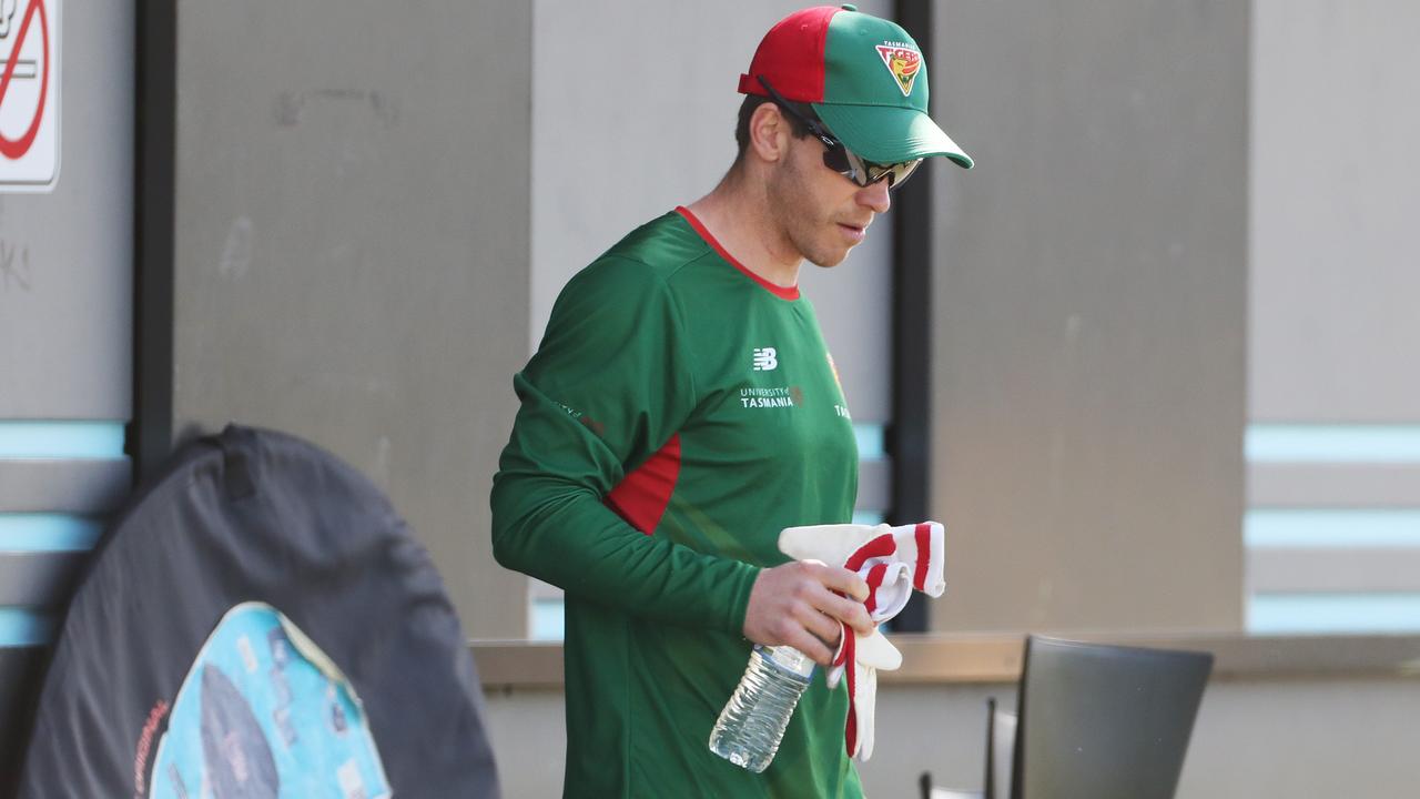 Paine grabs a bottle of water as he warms up for the Tasmania Second XI contest. Picture: Nikki Davis-Jones