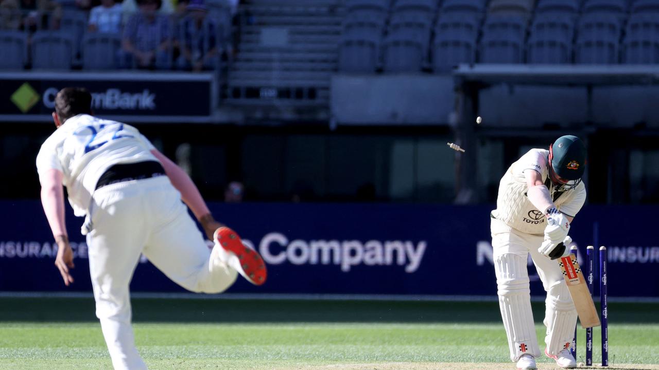 Travis Head’s stumps fly as he’s bowled for 11 by Harshit Rana. (Photo by COLIN MURTY/AFP)