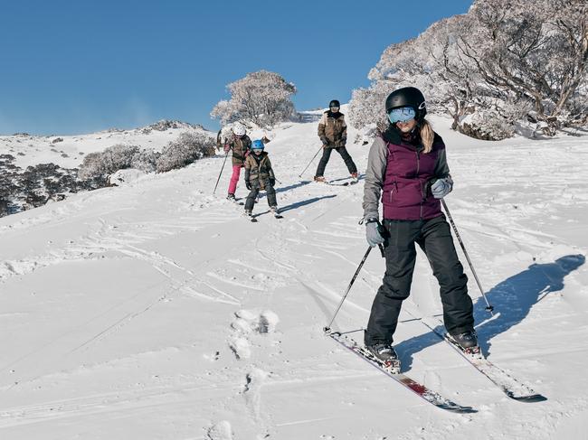 NSW SNOW SUPPLIED - Family enjoying a day of skiing at Charlotte Pass Ski Resort in the Snowy Mountains.