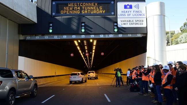 Workers, guests and media watch on as the first cars drive into the new WestConnex tunnel at Homebush. Picture: Bianca De March