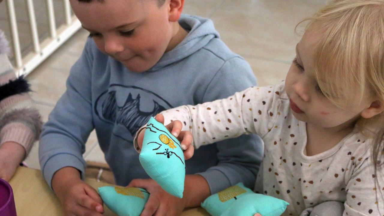 Cooper and Violette doing an activity with Jacinta.