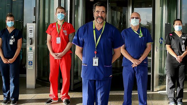 Royal Children's Hospital director of intensive care Warwick Butt (centre) with his team. Picture: Ian Currie