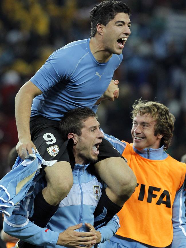 Suarez celebrates with teammates after Uruguay’s win over Ghana in 2010.