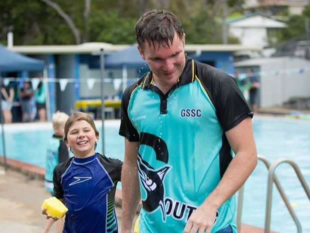 Coach Adam Eiseman with a young Kayden Gibson when the Gladstone South Swimming Club was first formed.