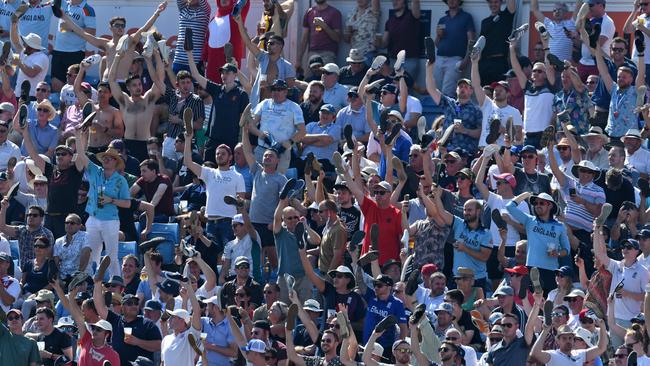 England fans wave their shoes in the air in support of their hero Stokes.