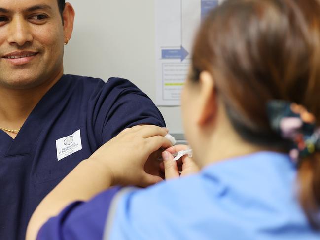 ADELAIDE, AUSTRALIA - NewsWire Photos March 17, 2021: Nepalese nurse Durga Basnet receives the Covid vaccine by Nga Tran at the Lyell McEwan Hospital in Elizabeth, Adelaide. Picture: NCA NewsWire / David Mariuz