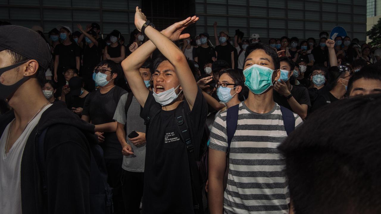 Protesters stand guard to block the street near the government headquarters. Picture: Billy HC Kwok/Getty Images