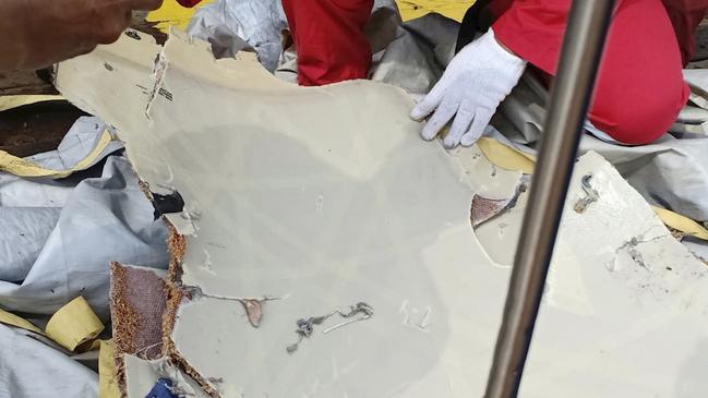 A rescuer inspects debris believed to be from the Lion Air passenger jet. Picture: AP