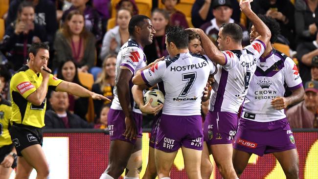 BRISBANE, AUSTRALIA — JUNE 30: Curtis Scott of the Storm is congratulated by team mates after scoring a try during the round 17 NRL match between the Brisbane Broncos and the Melbourne Storm at Suncorp Stadium on June 30, 2017 in Brisbane, Australia. (Photo by Bradley Kanaris/Getty Images)
