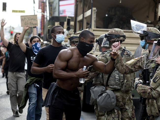 Demonstrators greet members of the National Guard as they march along Hollywood Boulevard. Picture: Ringo H.W. Chiu