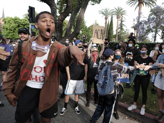 A Black Lives Matter protesters screams at a line of police during a protest outside Los Angeles Mayor Garcetti's house in Los Angeles. Picture: AP