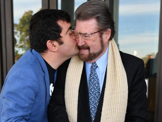 Labor Senator Sam Dastyari kisses Derryn Hinch's Justice Party Senator Derryn Hinch after cutting a Marriage Equality Cake at the Senate doors at Parliament House. Picture: AAP