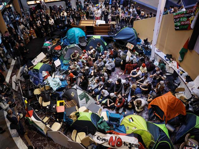 Pro-Palestinian students hold a sit-in in Melbourne on May 15, 2024 at Melbourne University's Arts West building, which the students have temporarily renamed as "Mahmoud's Hall" after Mahmoud Al Haq, a prospective University of Melbourne student, who died in Gaza. (Photo by Martin KEEP / AFP)